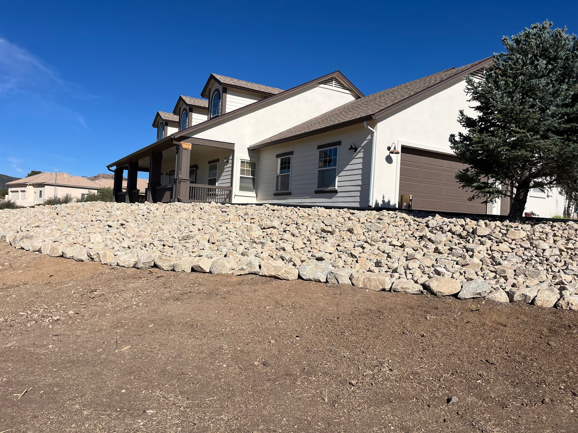 Granite Riprap Retaining Wall Built for a Hillside Home in Williamson Valley image